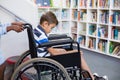 Schoolgirl pushing a boy on wheelchair Royalty Free Stock Photo