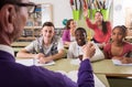 Schoolgirl raising hand to answer a lesson Royalty Free Stock Photo