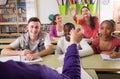 Schoolgirl raising her hand to answer a lesson Royalty Free Stock Photo