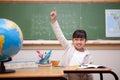 Schoolgirl raising her hand to answer a question Royalty Free Stock Photo