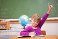 Schoolgirl raising her hand to ask a question Royalty Free Stock Photo