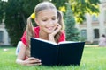 Schoolgirl read stories while relaxing green lawn. Cute pupil enjoy reading. School time. Interesting stories for kids