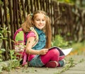 Schoolgirl reading a book on the street Royalty Free Stock Photo