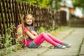 Schoolgirl reading a book on the street Royalty Free Stock Photo