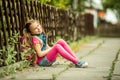 Schoolgirl reading a book on the street Royalty Free Stock Photo