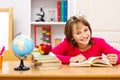 Schoolgirl reading in classroom