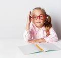 A schoolgirl with glasses at a table Royalty Free Stock Photo