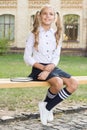 Schoolgirl relaxing sit on bench with book. Life balance. Pleasant minutes of rest. Time to relax and have fun. Relaxing Royalty Free Stock Photo