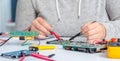 Schoolgirl repairing the electronic printed circuit board.Computer repair Royalty Free Stock Photo