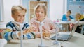 Schoolgirl and Schoolboy Work with Wind Turbine Prototype, Learning about Environment and Renewabl Royalty Free Stock Photo