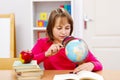 Schoolgirl searching with magnifier