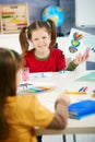 Schoolgirl showing painting in art class