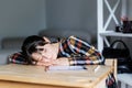 Schoolgirl is sleeping while doing homework, tired from studying, exhausted Royalty Free Stock Photo