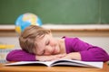 Schoolgirl sleeping on her desk Royalty Free Stock Photo