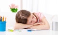 Schoolgirl sleeps on desk Royalty Free Stock Photo