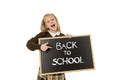 Schoolgirl smiling happy holding and showing small blackboard with text back to school Royalty Free Stock Photo