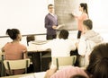 Schoolgirl solves task near blackboard in classroom mathematics Royalty Free Stock Photo