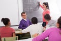 Schoolgirl solves task near blackboard in classroom mathematics Royalty Free Stock Photo