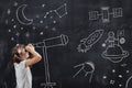 Schoolgirl looking through a telescope