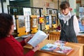 A schoolgirl stands in front of a female teacher