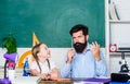 Schoolgirl study textbook. father and daughter study in classroom. education and knowledge. back to school. math Royalty Free Stock Photo