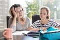 Schoolgirl studying with books on the kitchen