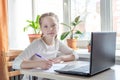 Schoolgirl studying at home using laptop. Home school  online education  home education  quarantine concept Royalty Free Stock Photo