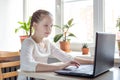Schoolgirl studying at home using laptop. Home school  online education  home education  quarantine concept Royalty Free Stock Photo