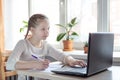 Schoolgirl studying at home using laptop. Home school  online education  home education  quarantine concept Royalty Free Stock Photo