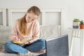 Schoolgirl studying at home using laptop. Social distance, self- isolation. Online education, quarantine concept Royalty Free Stock Photo