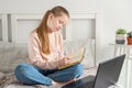 Schoolgirl studying at home using laptop. Social distance, self- isolation.Online education, quarantine concept Royalty Free Stock Photo