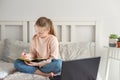 Schoolgirl studying at home using laptop. Social distance, self- isolation. Online education, quarantine concept Royalty Free Stock Photo