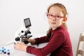 Schoolgirl with modern microscope Royalty Free Stock Photo