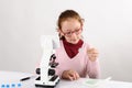 Schoolgirl with modern microscope Royalty Free Stock Photo