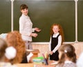 Schoolgirl and teacher near a school board Royalty Free Stock Photo