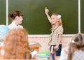 Schoolgirl and teacher near a school board Royalty Free Stock Photo