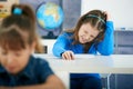 Schoolgirl thinking in classroom