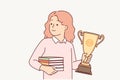 Schoolgirl with trophy gold cup and books in hands rejoices in victory in school olympiad