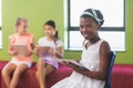 Schoolgirl using digital tablet in library Royalty Free Stock Photo