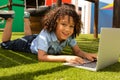 Schoolgirl using laptop in the school playground