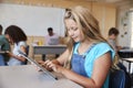 Schoolgirl using tablet in elementary school class, close up