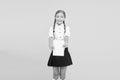 Schoolgirl wear school uniform. Knowledge day. Girl with copy book or workbook. Kid student ready with homework. School Royalty Free Stock Photo