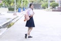 Schoolgirl in a white dress is going to school. Royalty Free Stock Photo