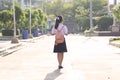 Schoolgirl in a white dress is going to school. An Asian student in a white school uniform stands on the road to prepare to go to Royalty Free Stock Photo