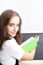 Schoolgirl writes on a board