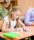 Schoolgirl writes the exam in class