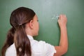 Schoolgirl writing an addition Royalty Free Stock Photo