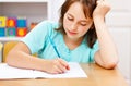 Schoolgirl writing boring homework Royalty Free Stock Photo