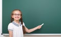 Schoolgirl writing chalk on a blackboard, empty space, education concept