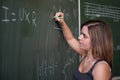 Schoolgirl writing on the chalkboard Royalty Free Stock Photo